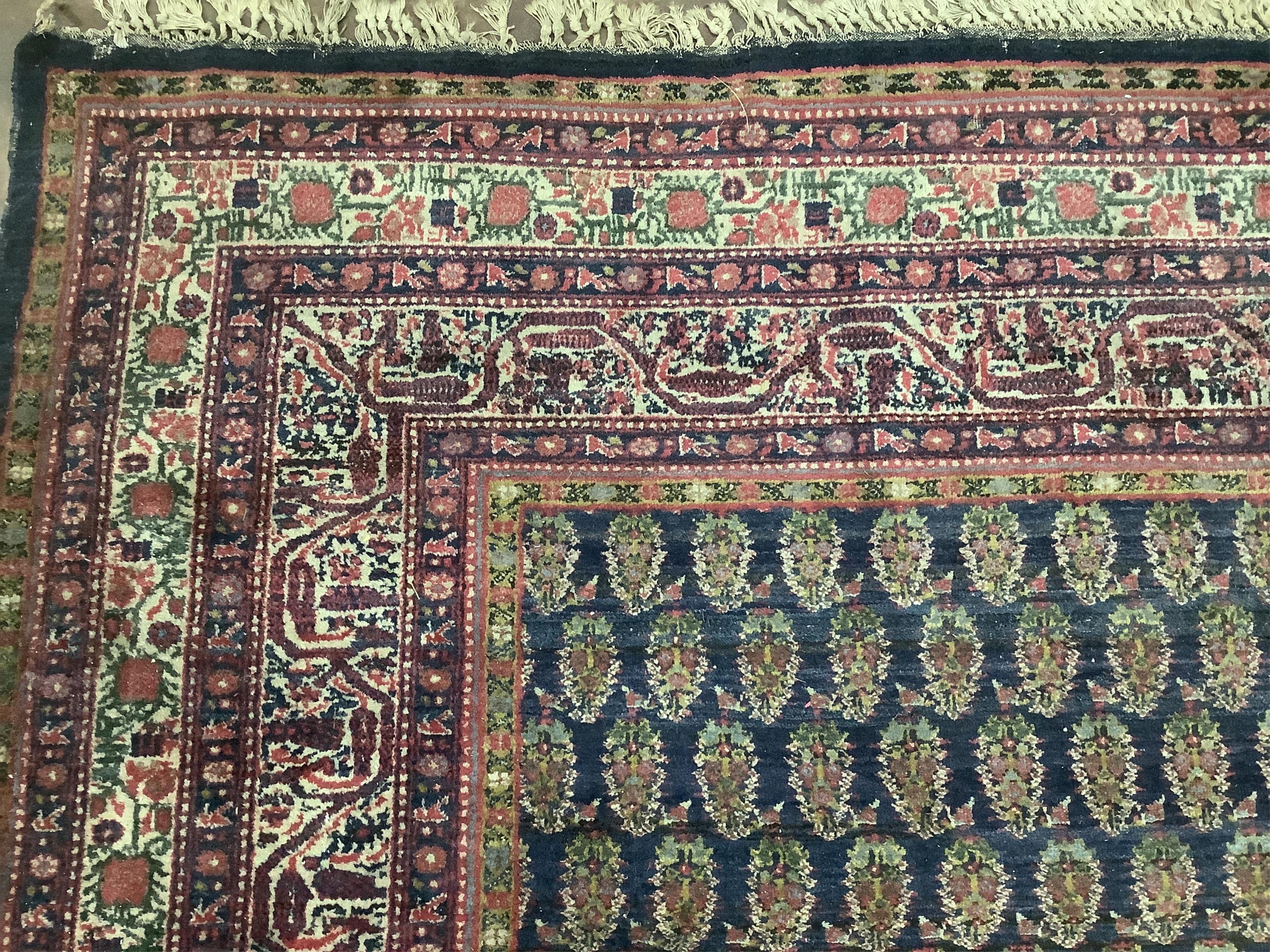 A Serabend blue ground boteh carpet, approximately 406 x 334cm. Condition - poor